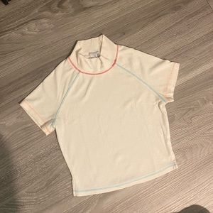 White mock neck crop top with colorful stitching
